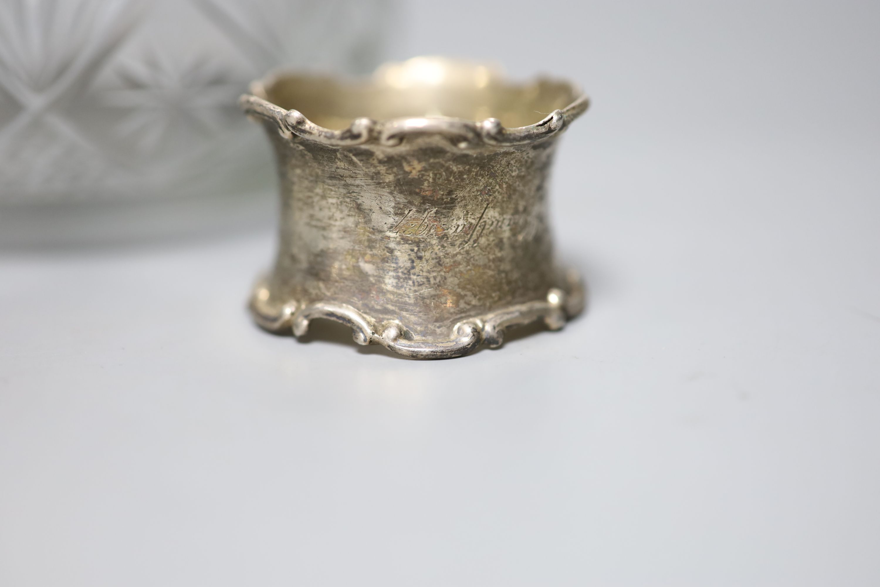 A 1920's silver mounted cut glass powder bowl, a similar small hair tidy and a silver napkin ring.